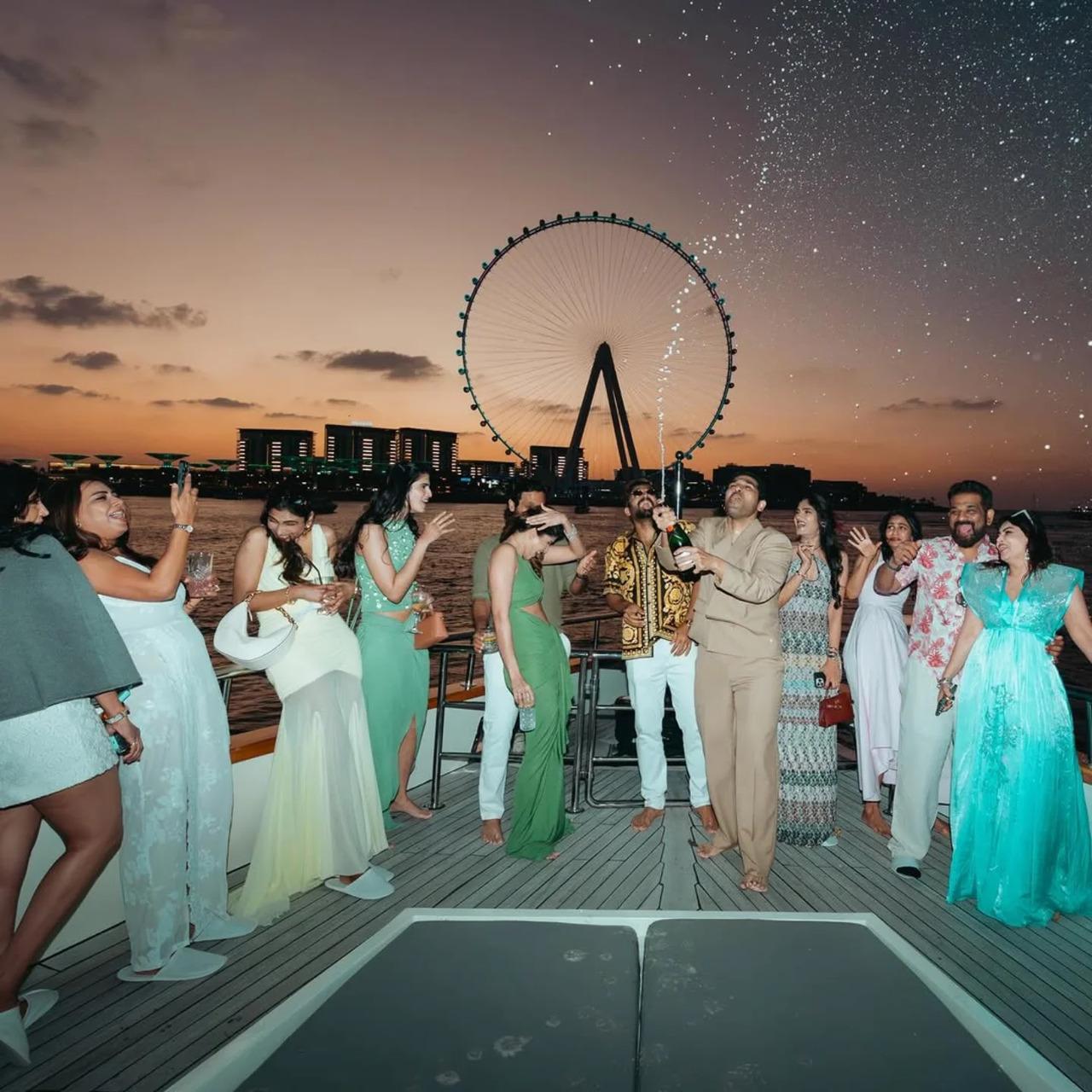 <p>In one of the viral videos, Sirish pops a champagne bottle and sprays it into the air while guests cheer and celebrate around him.</p>